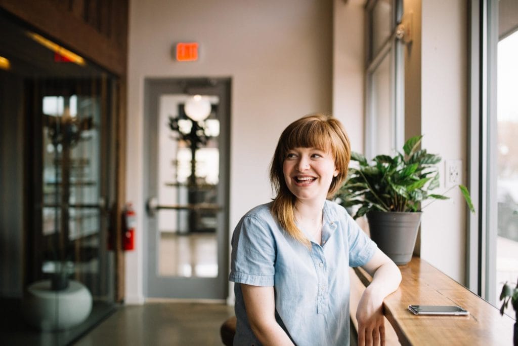 Hiring manager relaxing in office, and enjoying time with co-workers, as a benefit of employee retention