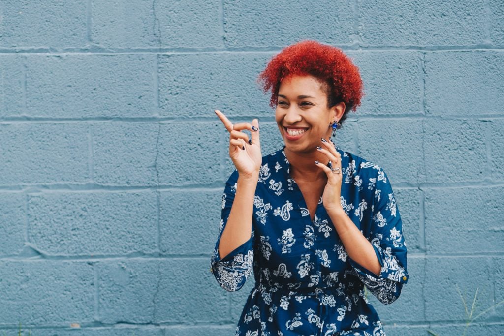 Happy woman enjoying time outside after following pre-hire assessment best practices