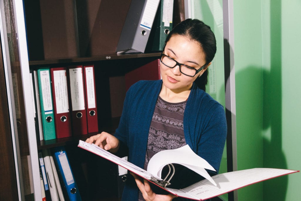 Office woman reading binder and hiring for soft skills