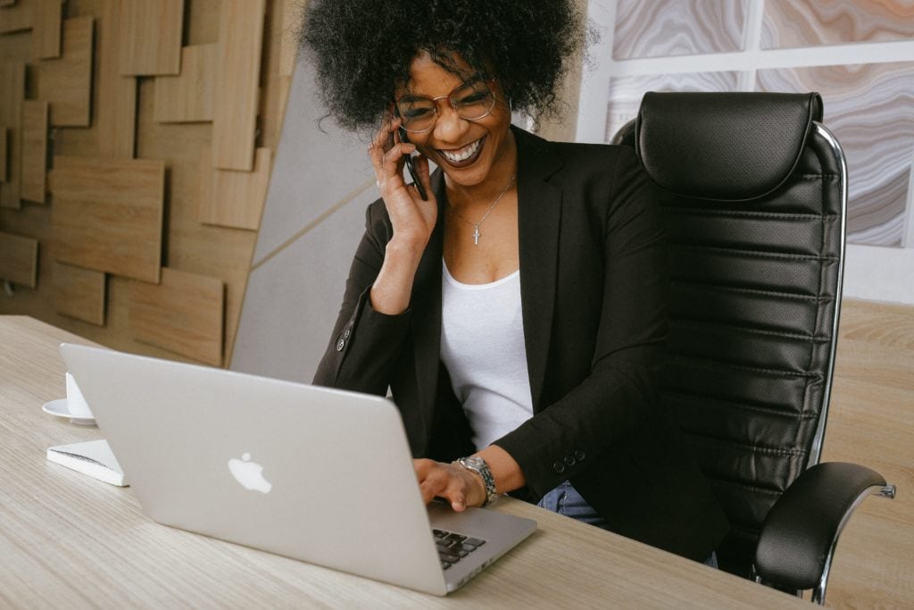 Office Woman on the phone and laptop creating a recruiting workflow