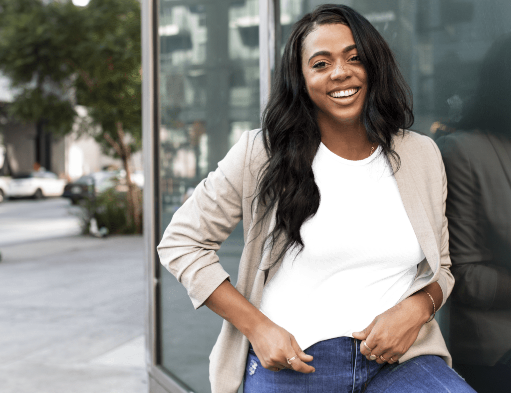 woman smiling outside of office after raising the offer acceptance rate