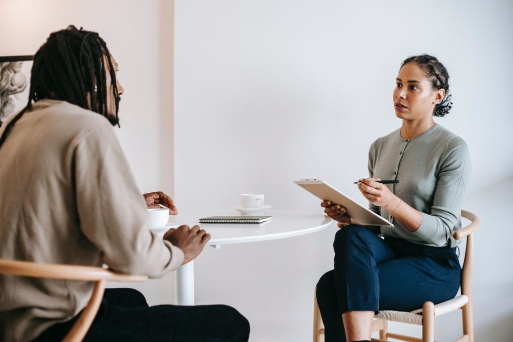 Two women interviewing another woman. Trust and communication between recruiters significantly improves the hiring experience for everyone