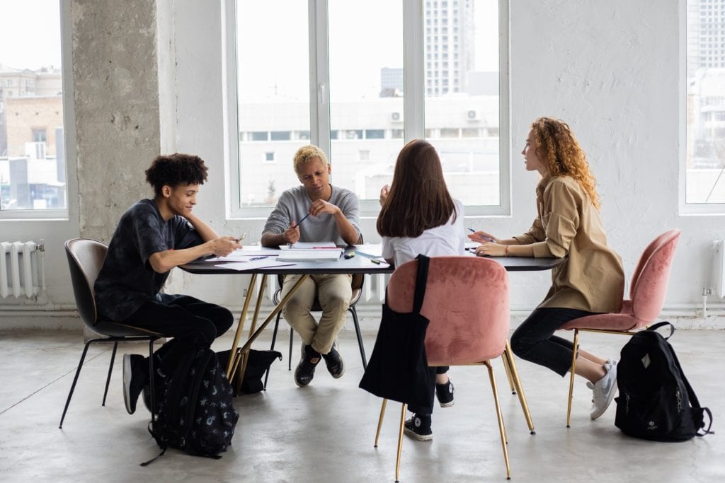 a diverse board at a company holding a meeting in a boardroom