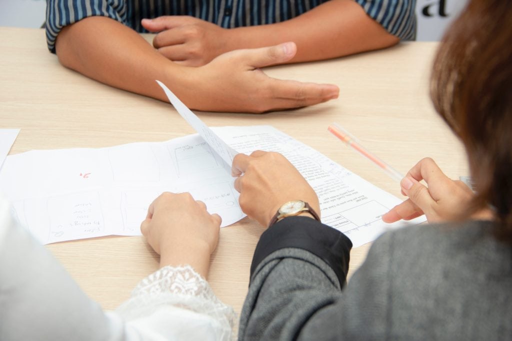 reviewing a resume for job application while interviewing a candidate