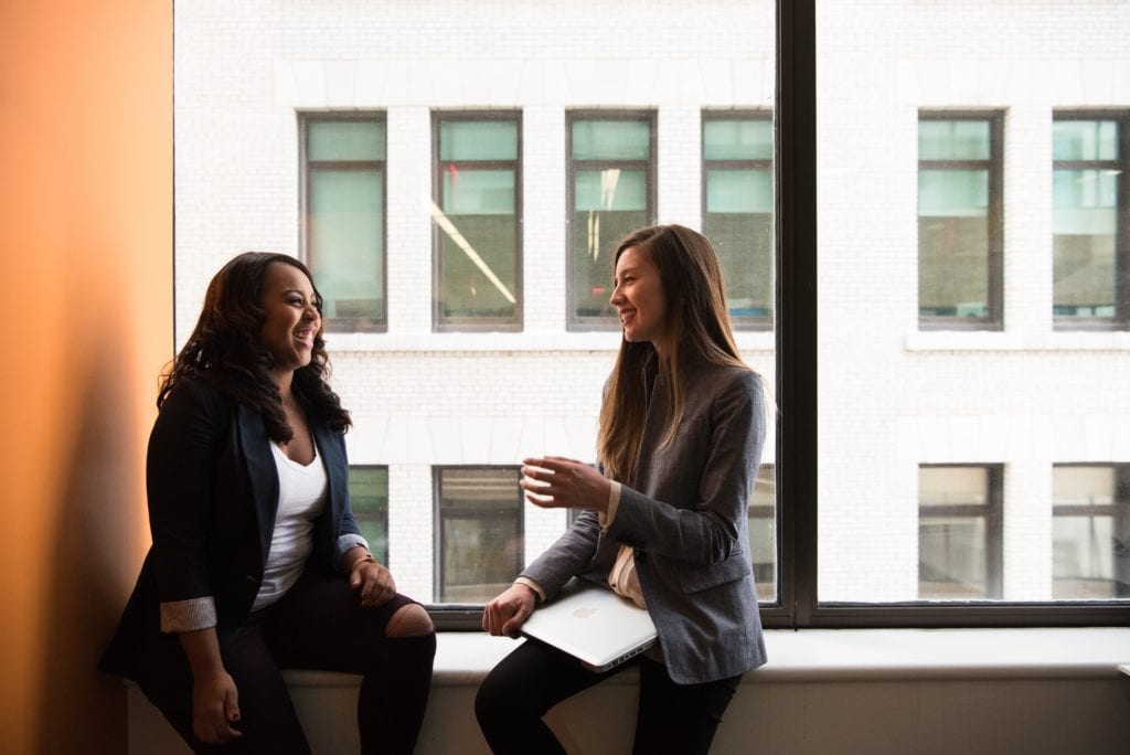two employees having a conversation about culture fit in a diverse workplace