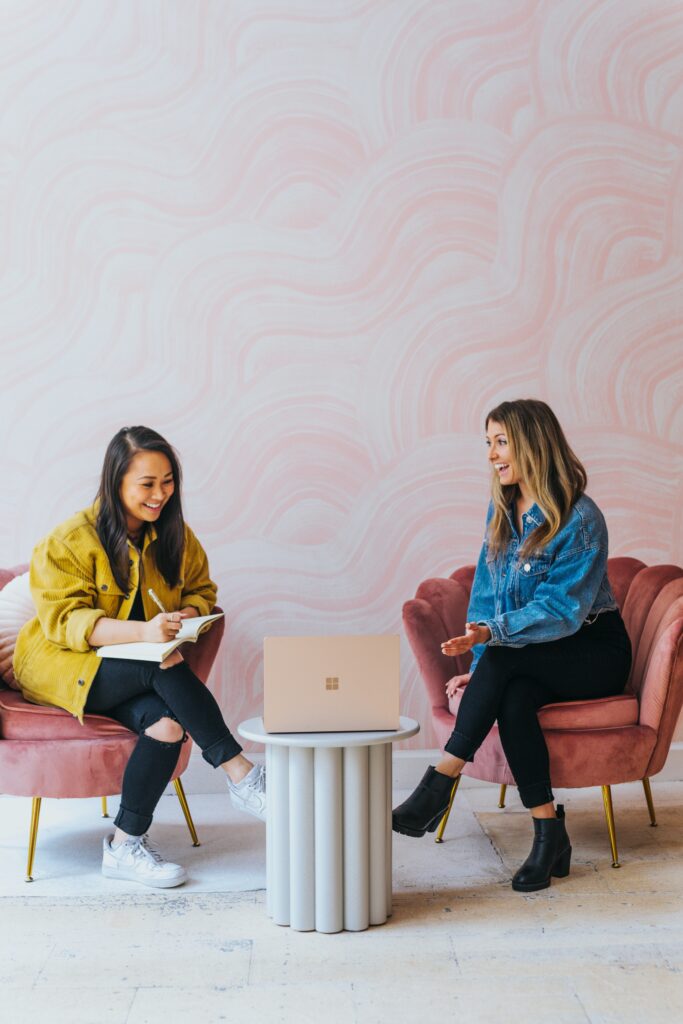 two HR professionals discussing supporting women in the workplace