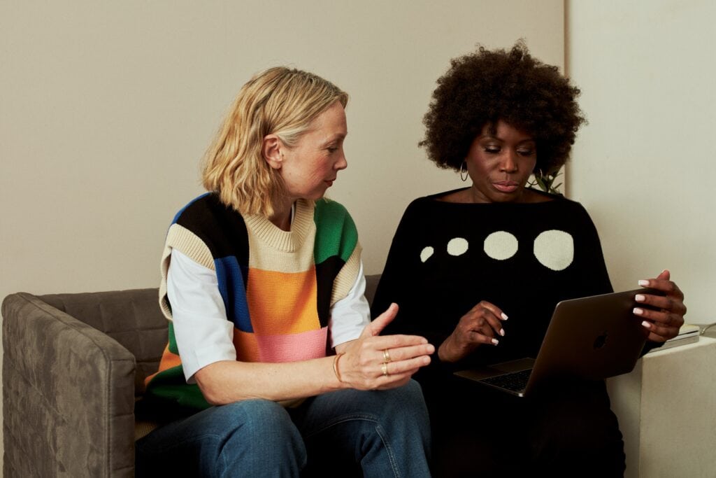 two recruiters using AI in HR to make better talent management decisions