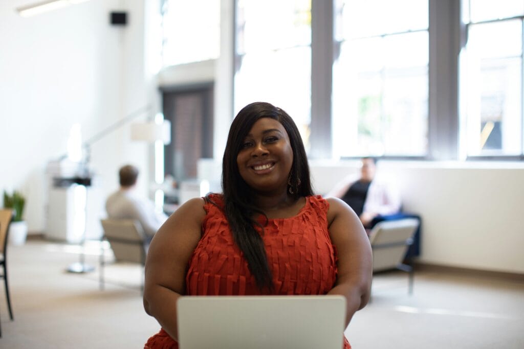 Woman sitting at laptop signing up for Cangrade's Women & Minority Owned Business discount