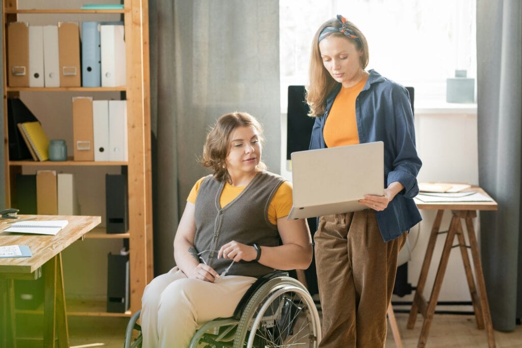 Two HR employees reviewing a talent assessment on a laptop
