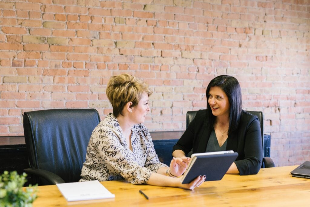 Two HR professionals discussing interview questions for a candidate
