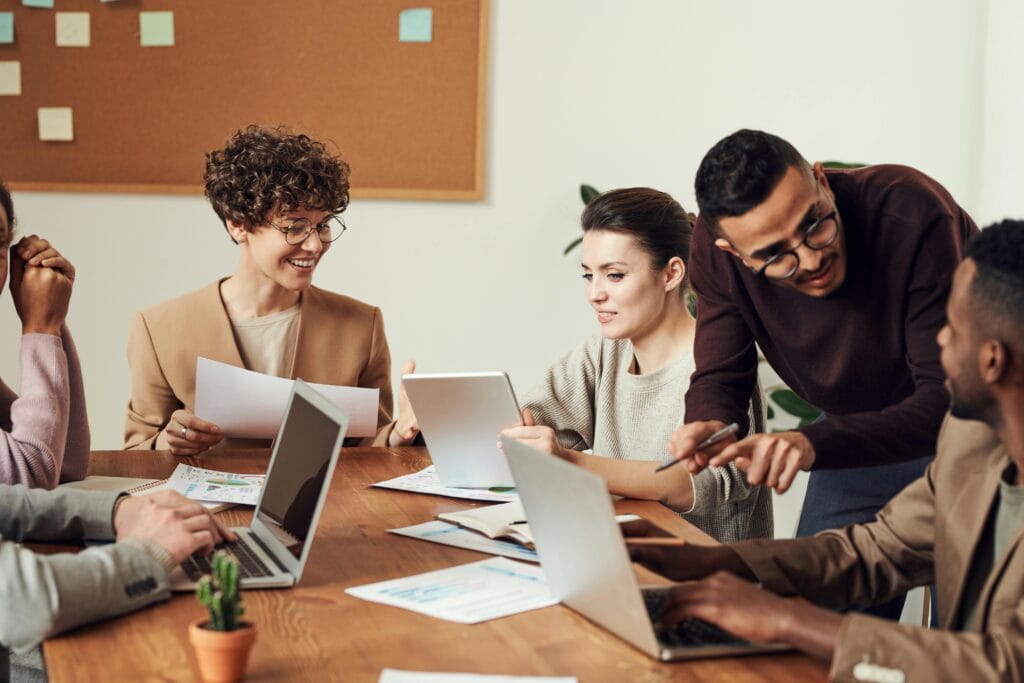 An HR team sitting around a table discussing closing skills gaps using AI.