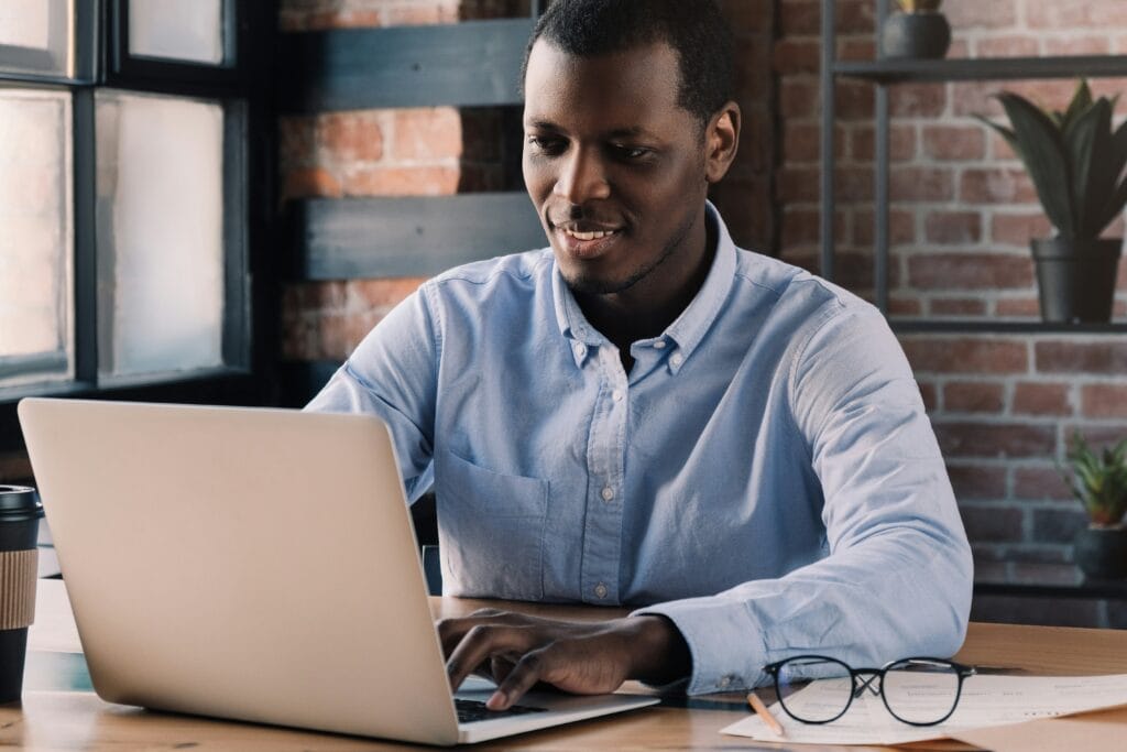 Man at laptop working hard skills strategy.