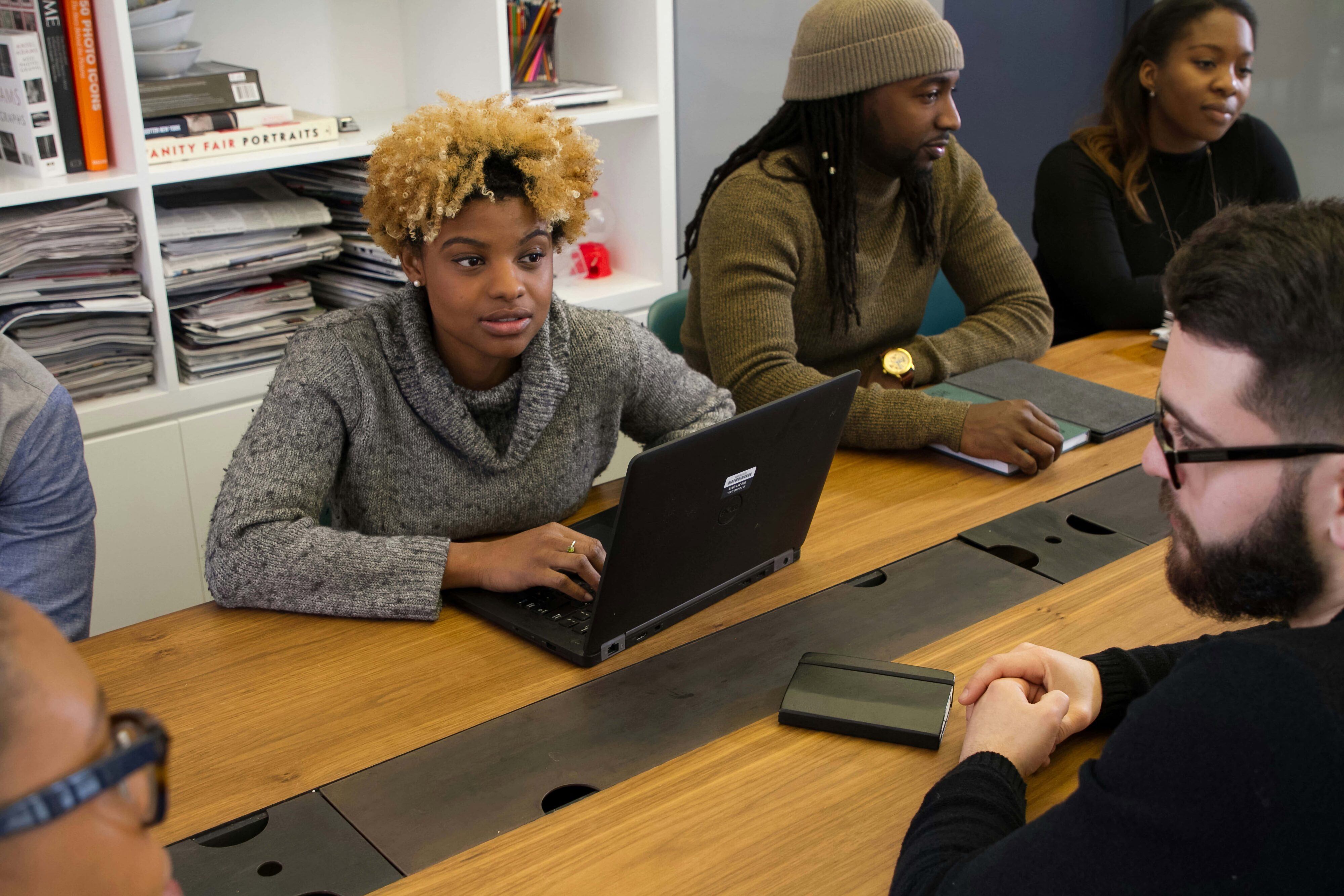 Employees sitting around a conference table discussing civility at work.