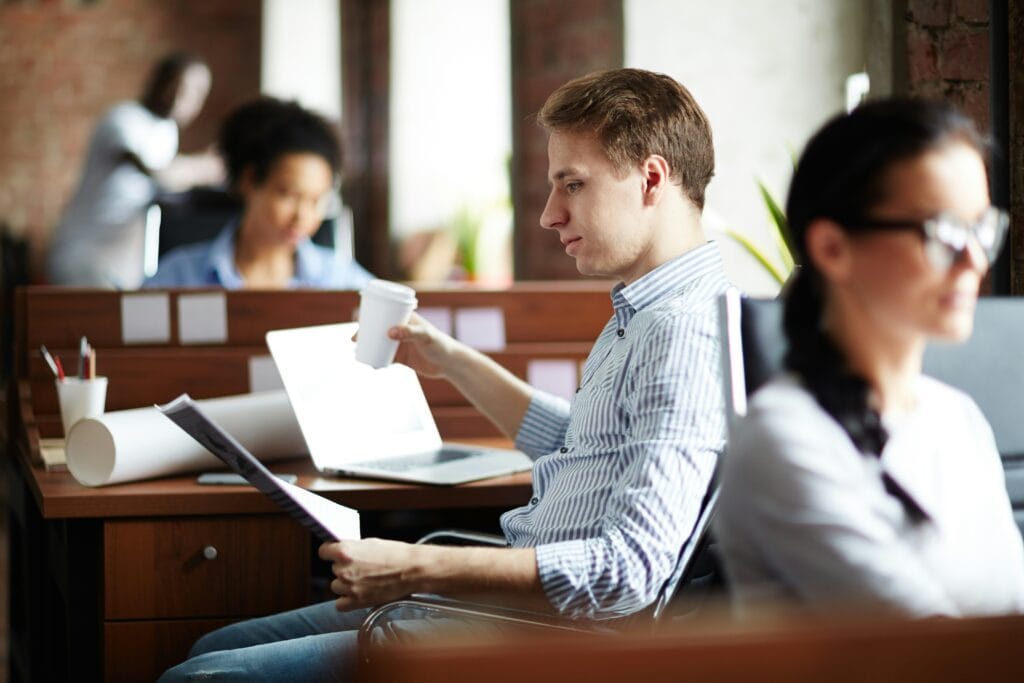Man sitting at his desk reviewing a report on candidate screening