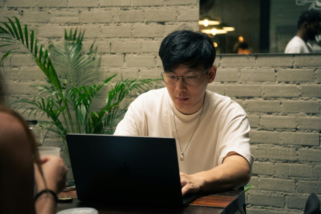 A candidate sitting at a laptop taking using an AI job simulation.