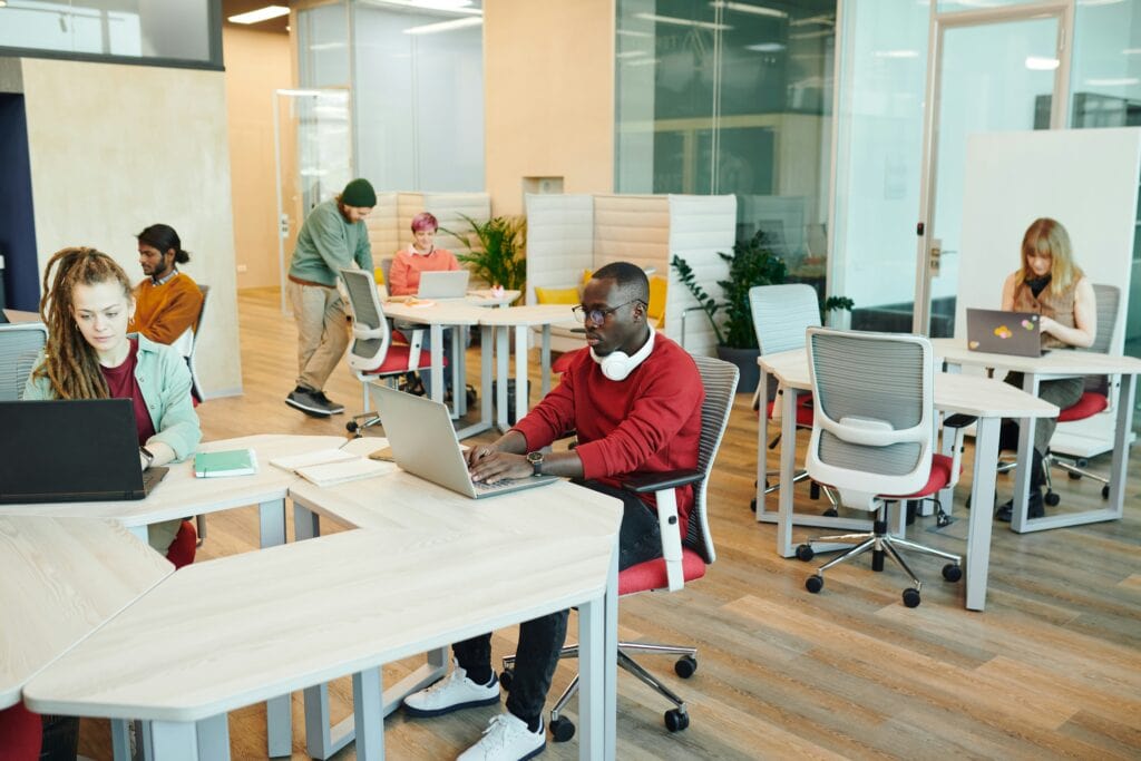 Man sitting at a laptop using the AI Hiring Tool Evaluation Checklist.