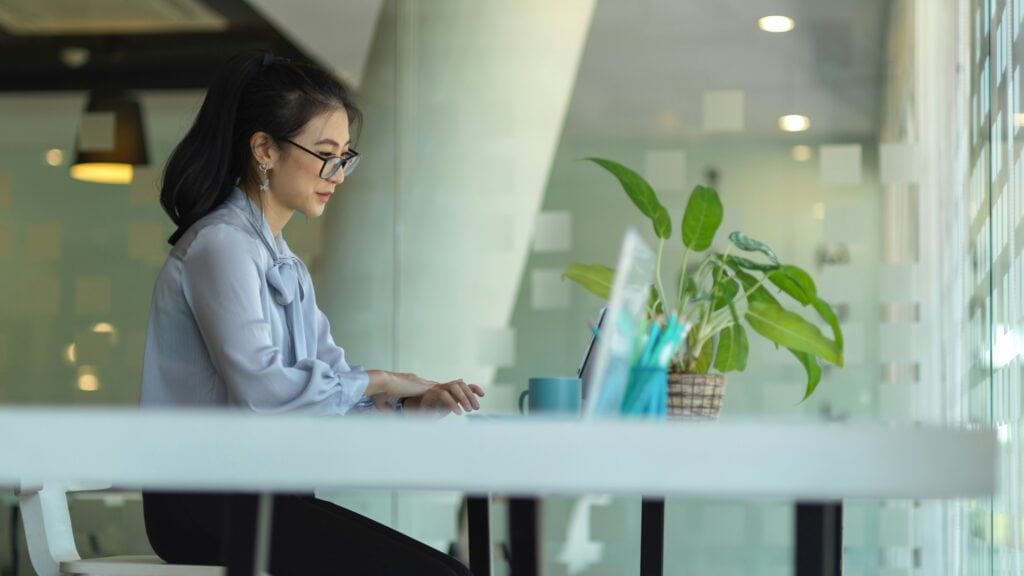 Woman sitting at laptop learning about responsible AI in HR